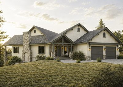 Front view of a single-story custom home with cream stucco walls, prominent stone chimney, gabled rooflines, covered entry porch, and two-car garage set on sloped terrain